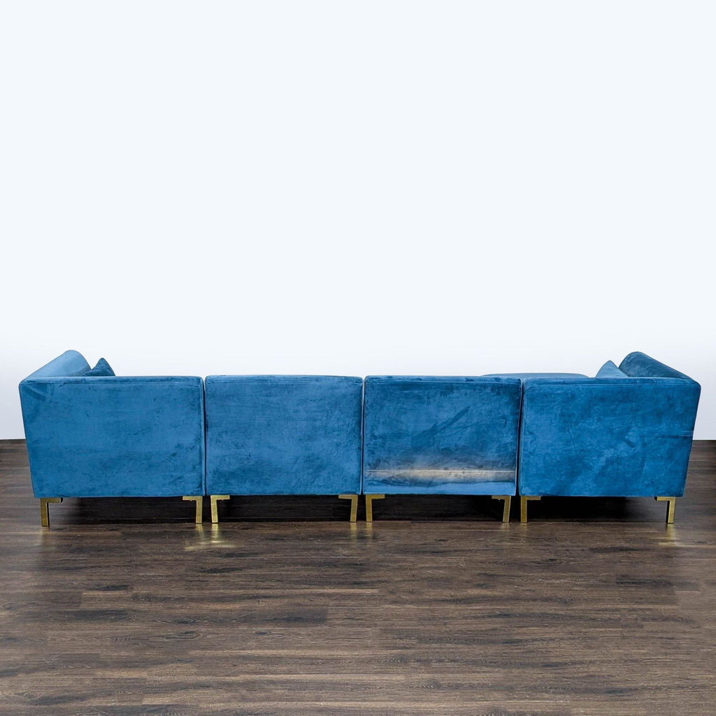 3. Rear view of the Chic Home blue sectional sofa, featuring soft upholstery and sturdy gold metal legs.
