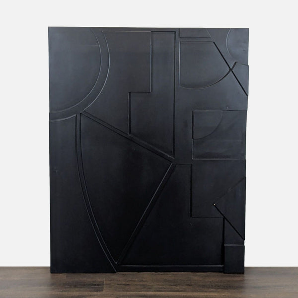 1. Black wall art panel by CB2 featuring raised geometric shapes and lines, displayed upright against a white background.