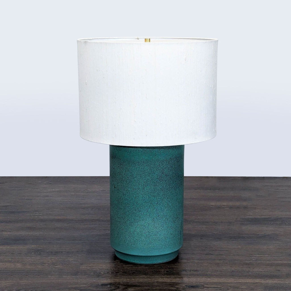 Contemporary green and white CB2 table lamp with ceramic base, perfect for desks, nightstands, or living rooms.