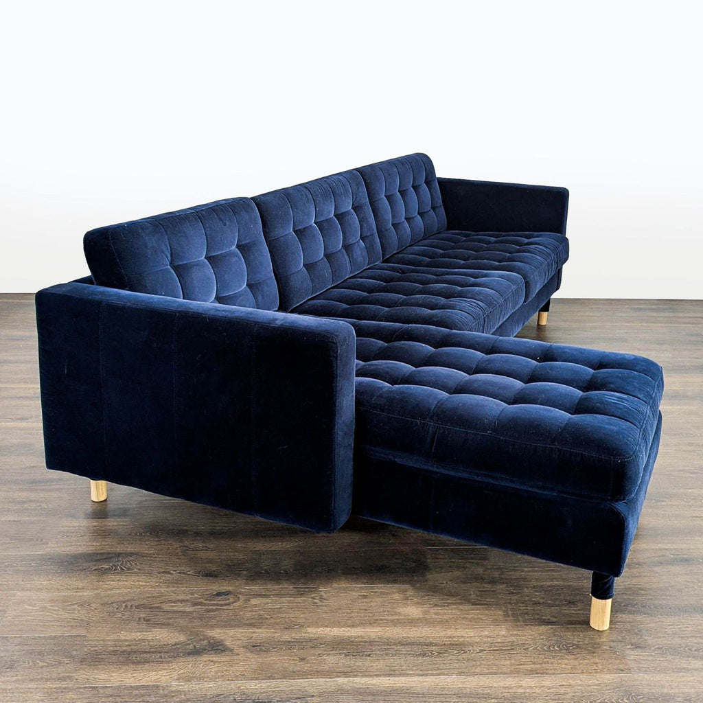 Modern IKEA sectional sofa in blue velvet with a chaise lounge and wooden legs; gently used, excellent condition.
