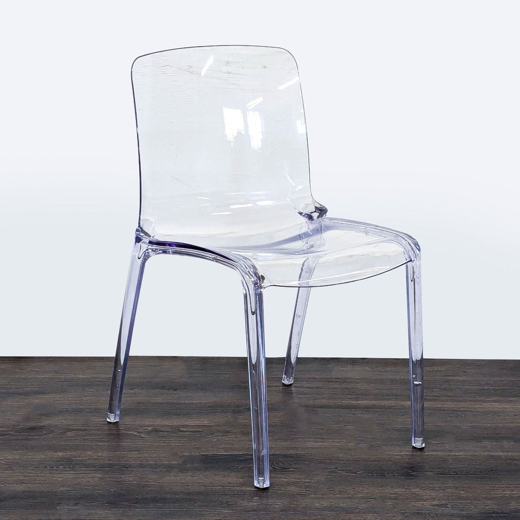 Modern dining chair from LeisureMod, combining a clear acrylic seat with a sturdy metal frame.