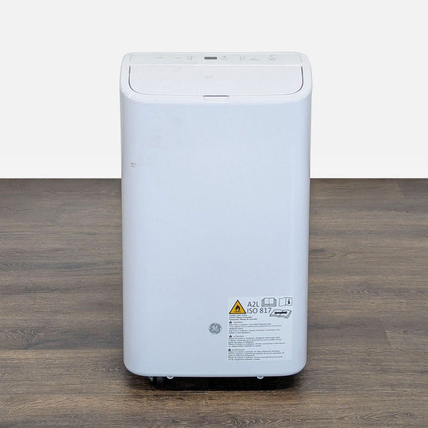 GE portable air conditioner with digital controls and display, compact design, fits any home or office space.