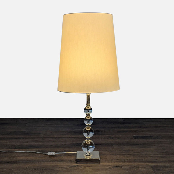 Ikea table lamp with clear glass ball accents, white shade, and sturdy metal base, ideal for home lighting.  