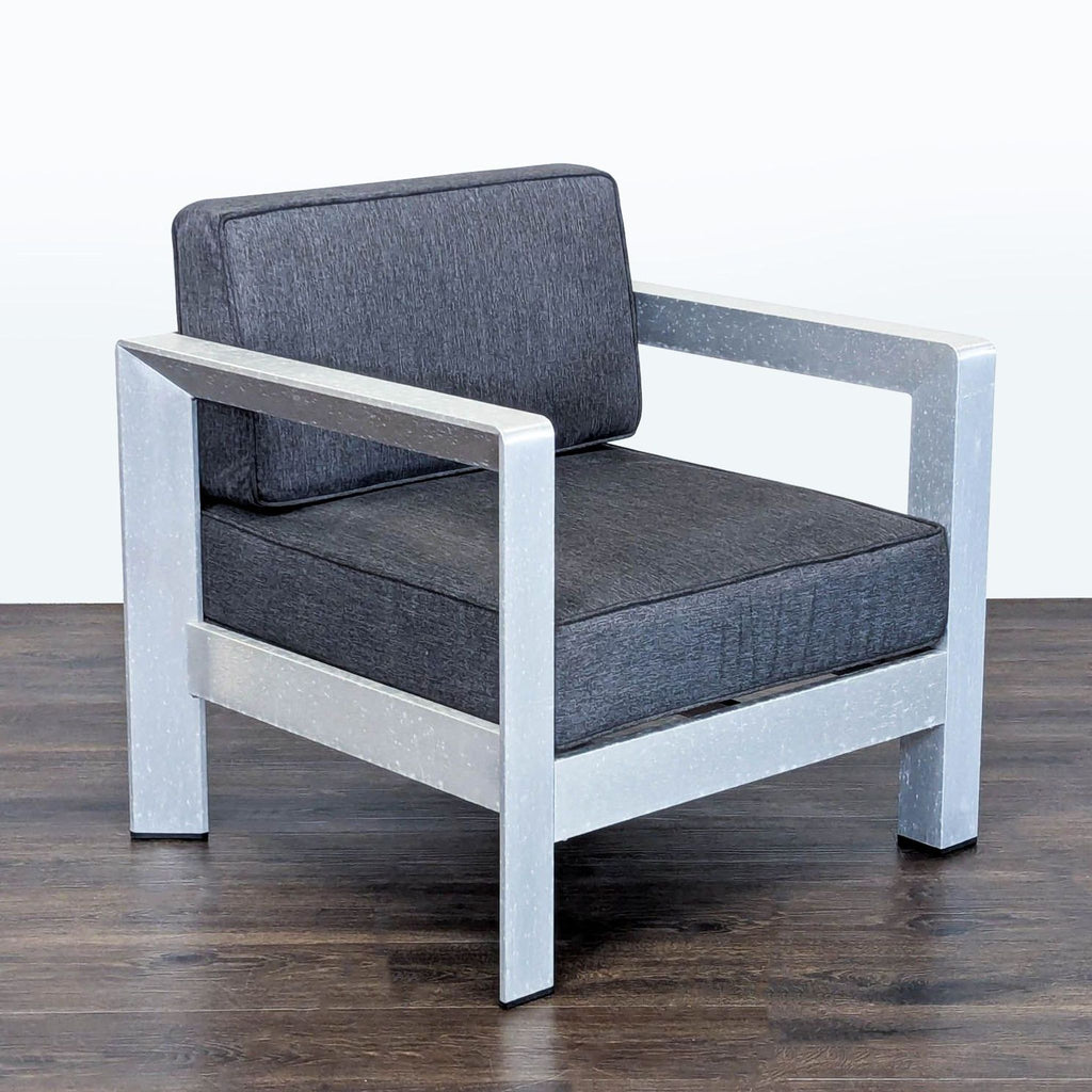 Contemporary chair by Christopher Knight with plush dark cushions and metal frame, perfect for outdoor seating.