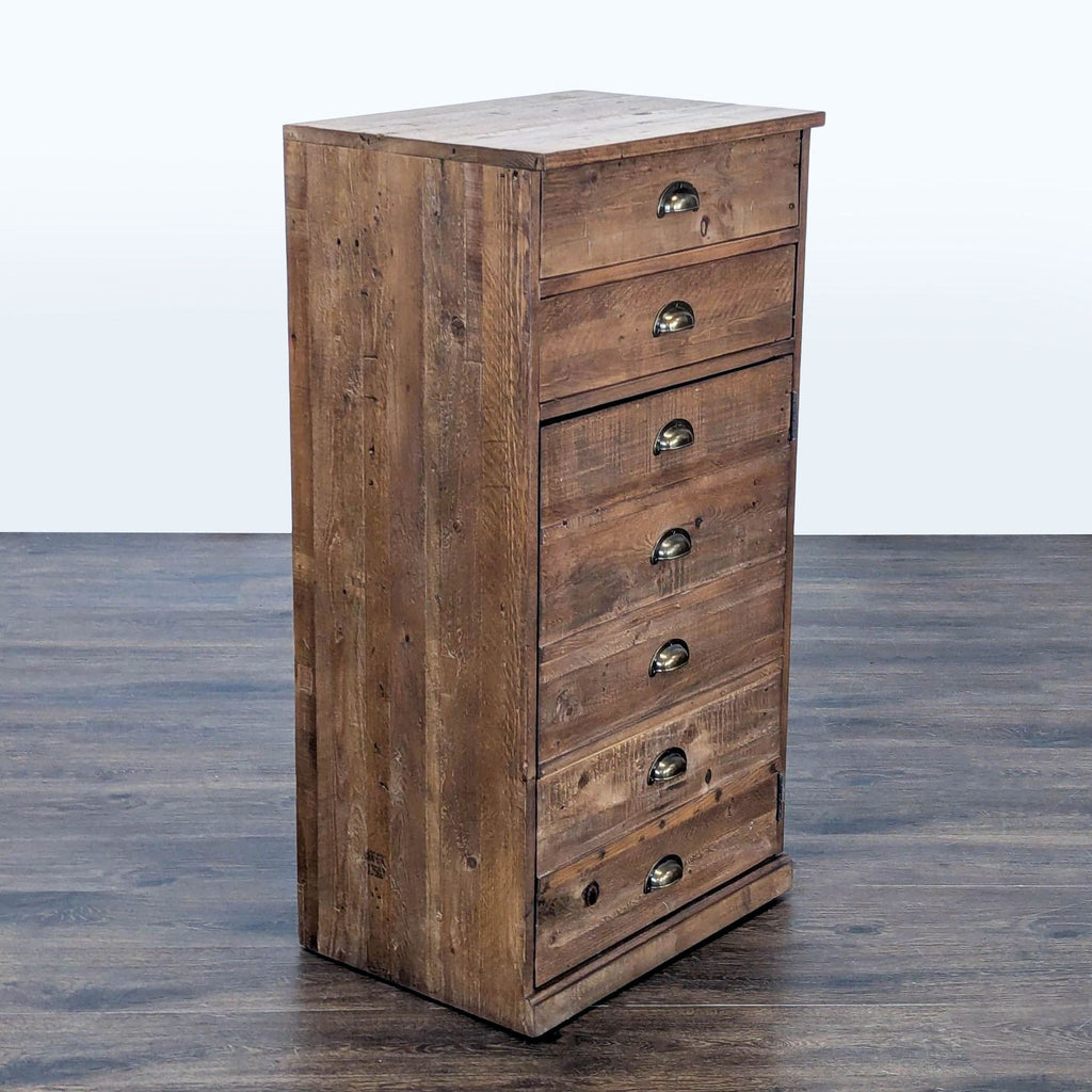 Cabinet from Pottery Barn, crafted in reclaimed wood, includes multiple drawers and a shelf inside.