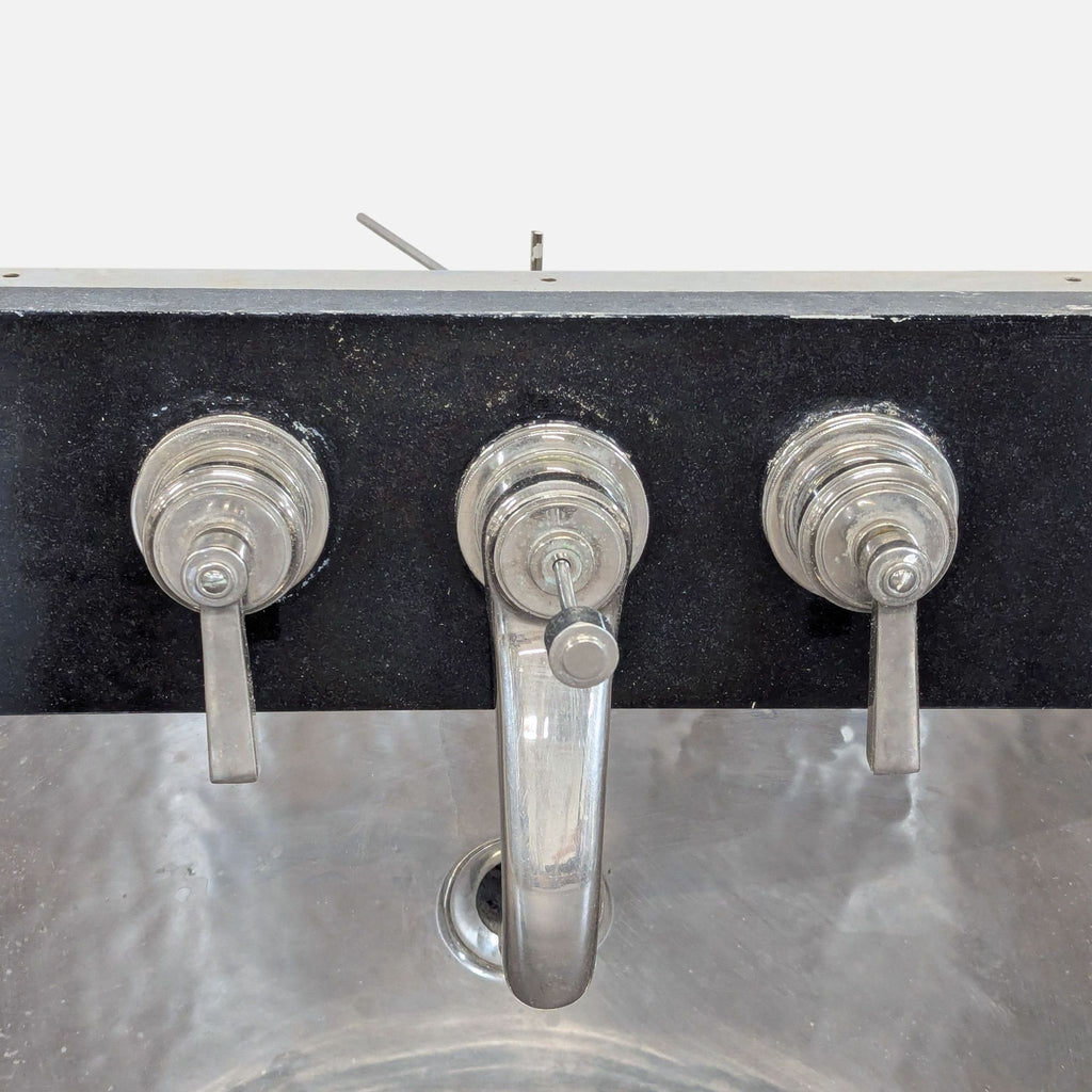 Sleek Waterworks nickel sink with stone backplate and durable three-piece faucet, perfect for modern spaces.
