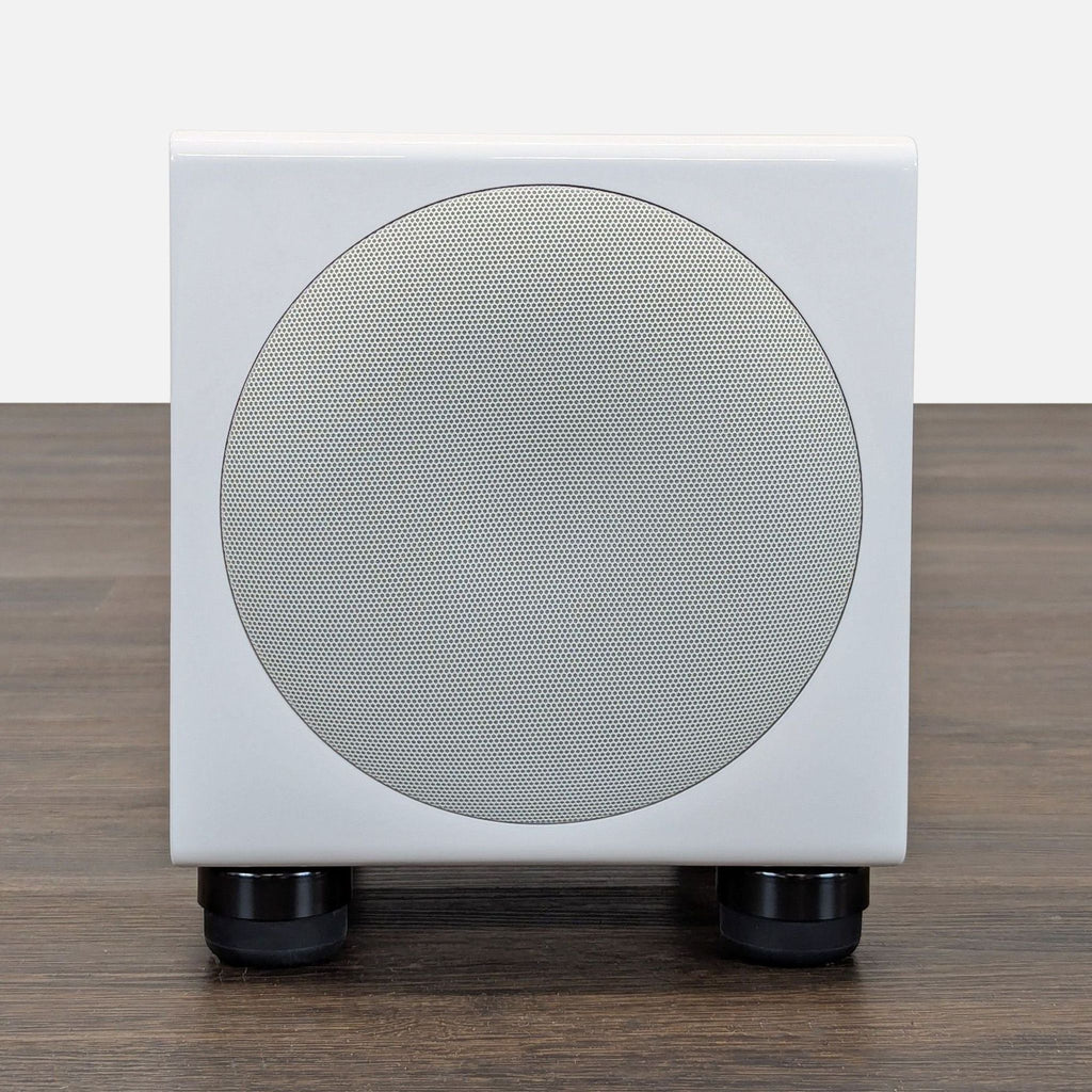White SVS compact subwoofer with a sleek, modern design for powerful bass in home audio setups.