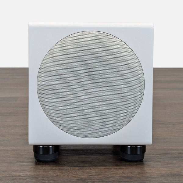 White SVS compact subwoofer with a sleek, modern design for powerful bass in home audio setups.