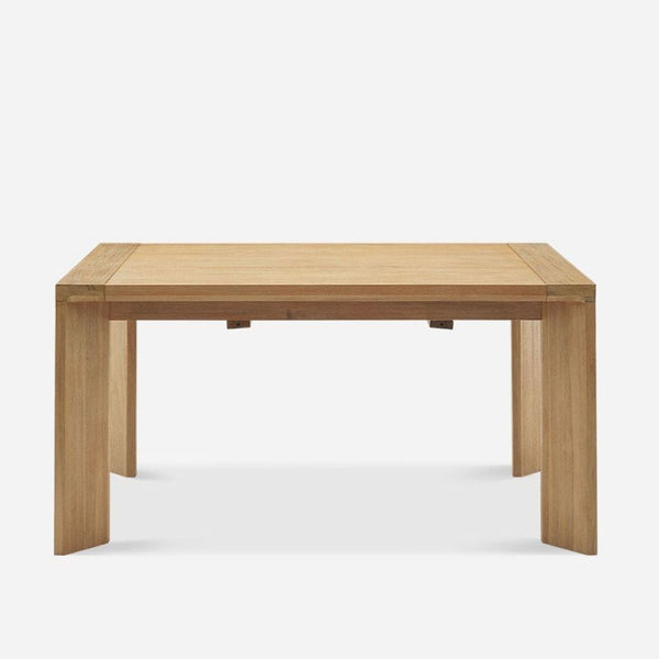 Minimalist Castlery dining table with angled blade legs, extends up to 80.3 inches for added seating.  