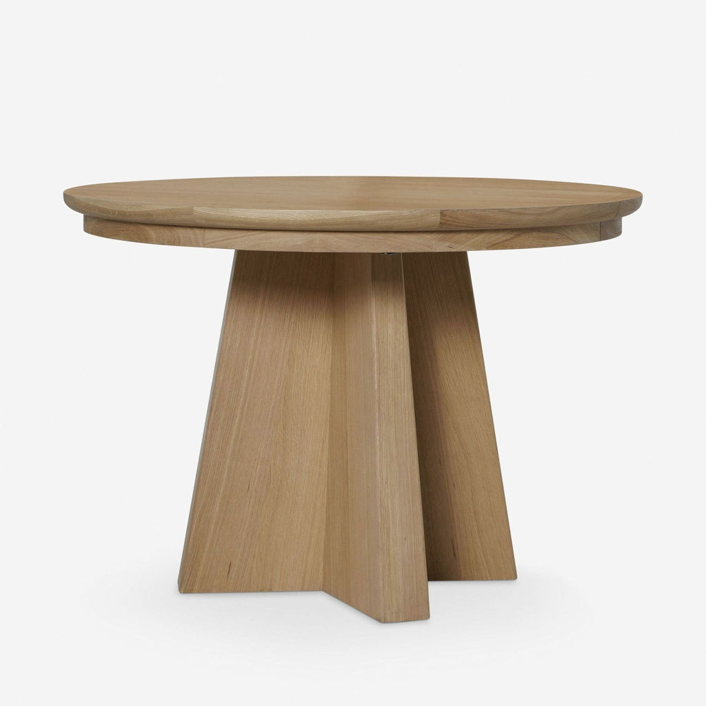Round oak dining table by Lulu and Georgia, extends to oval with two angular legs for larger gatherings.