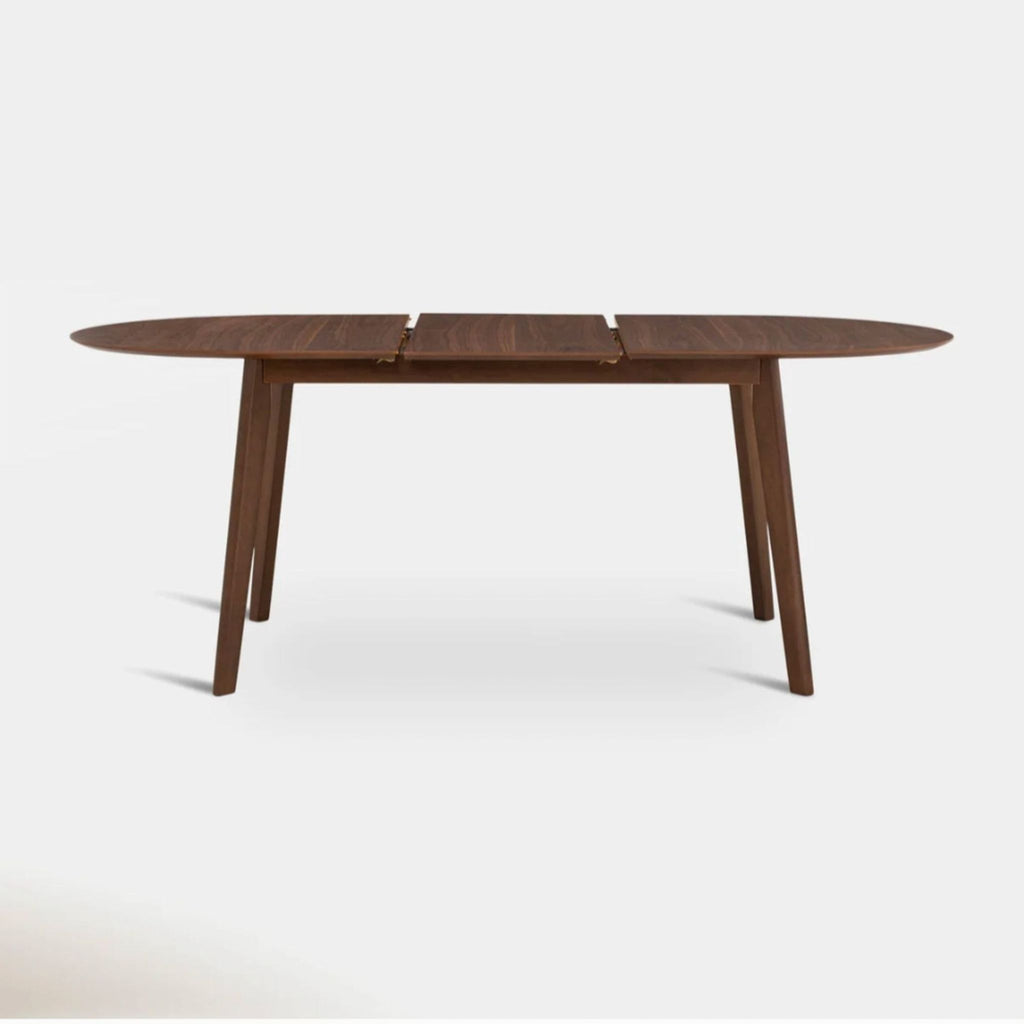 Rectangular Hoft dining table in walnut, extendable with a butterfly leaf, suited for small to mid-size gatherings.