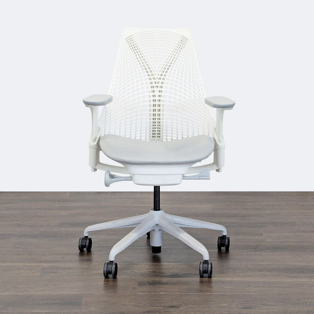 White Herman Miller office chair with mesh back, adjustable armrests, and wheels, ideal for ergonomic seating.