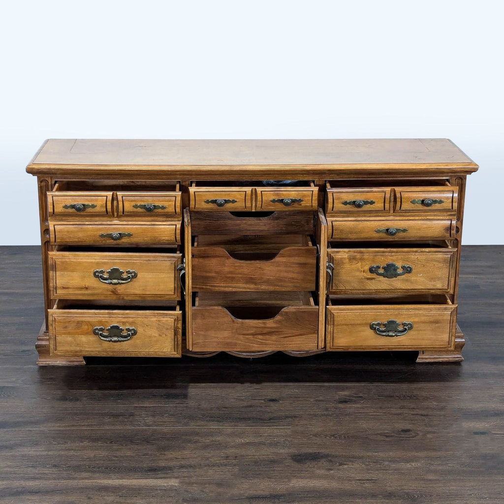 Classic dresser featuring ten drawers and a middle cabinet, finished in natural wood with retro metal handles.