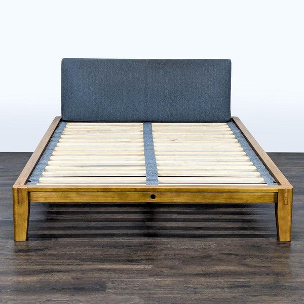 Thuma solid wood bed frame with upholstered gray headboard and sturdy slat support shown in modern bedroom.  