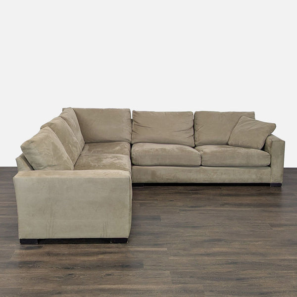 Spacious L-shaped Room & Board sectional with dark beige upholstery and plush cushions for comfortable seating.  