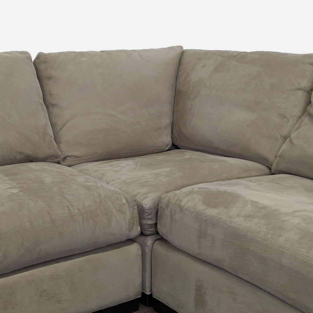 Modern L-shaped sectional by Room & Board, upholstered in dark beige fabric, ideal for relaxing or entertaining.