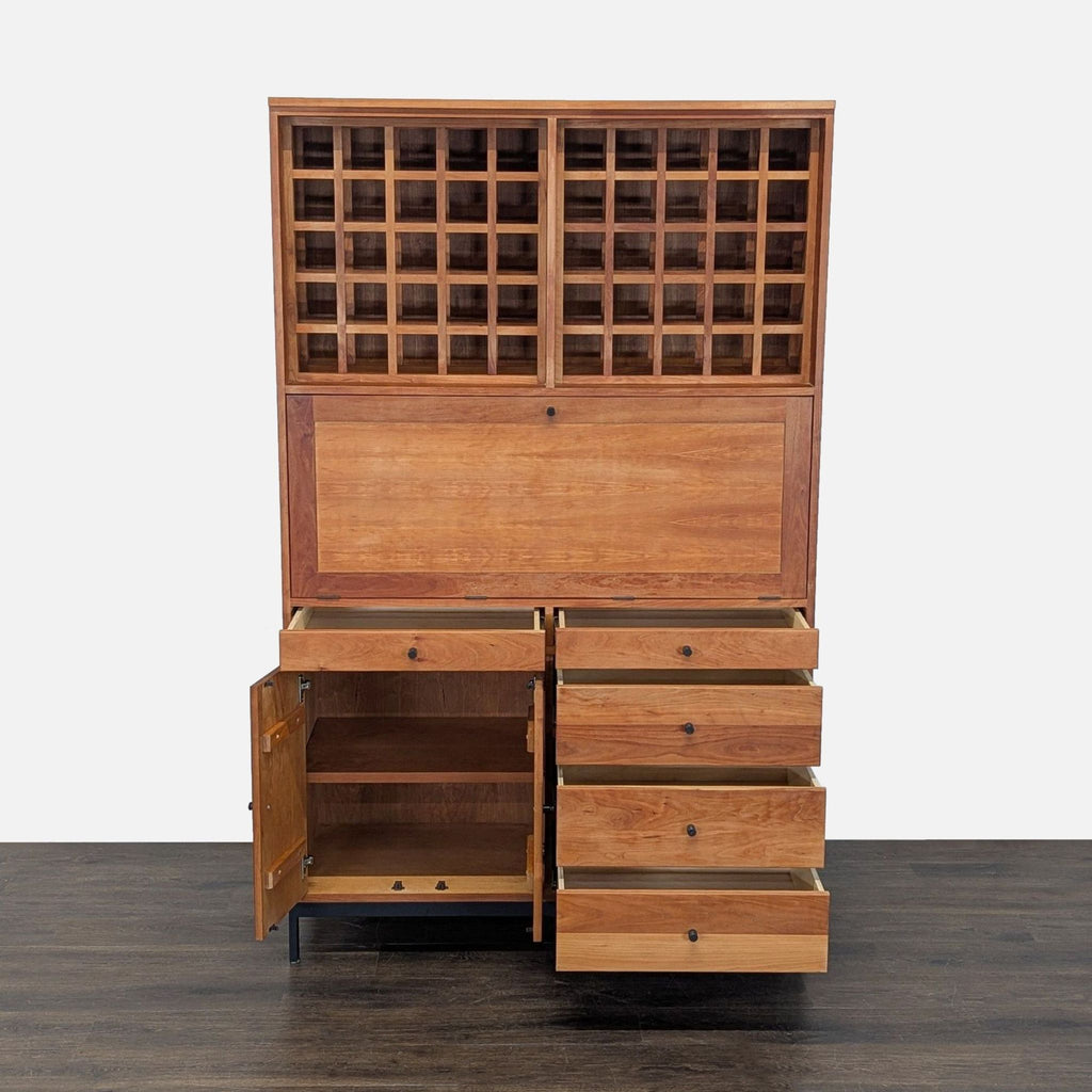 Modern cherry wood and steel cabinet with wine racks, drawers, shelving, and pull-out bar; by Room & Board.