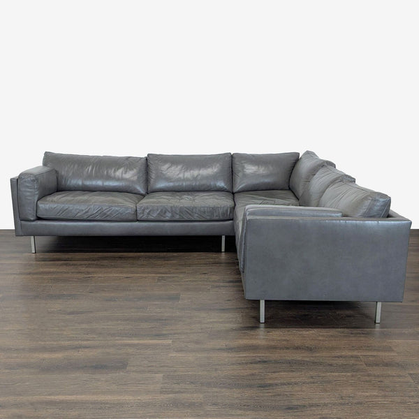 BenchMade Modern gray leather sectional with L-shape, plush cushions, and metal legs for a sleek look.  