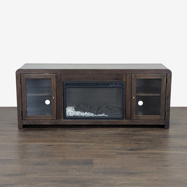 Living Spaces Kabria entertainment center with glass doors and built-in electric fireplace displaying flame effect.  