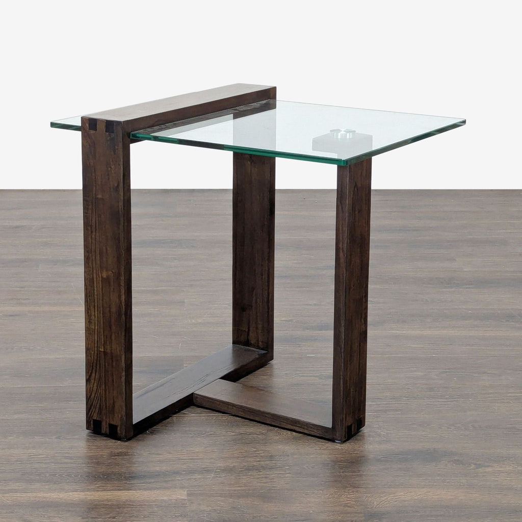 Modern end table with a mindi wood frame and a sleek glass top by Living Spaces.  