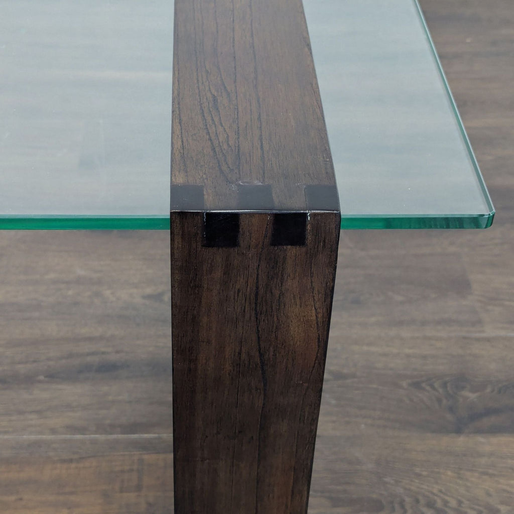 Contemporary end table showcasing a glass top supported by an elegant mindi wood frame.