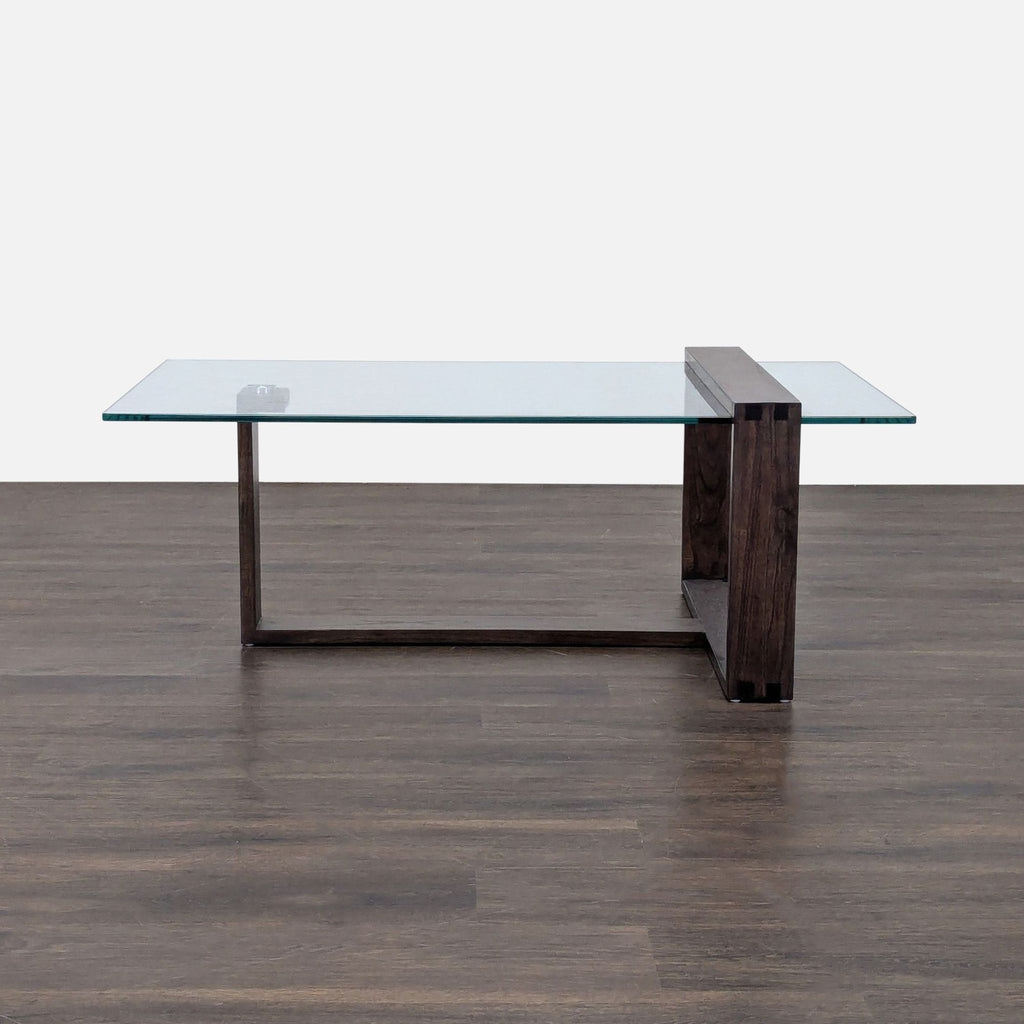 Living Spaces coffee table with Mindi wood base and tempered glass top, modern design.