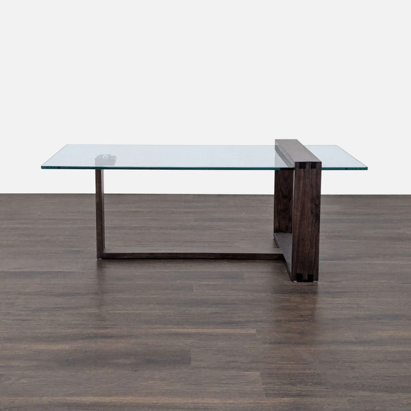 Living Spaces coffee table with Mindi wood base and tempered glass top, modern design.