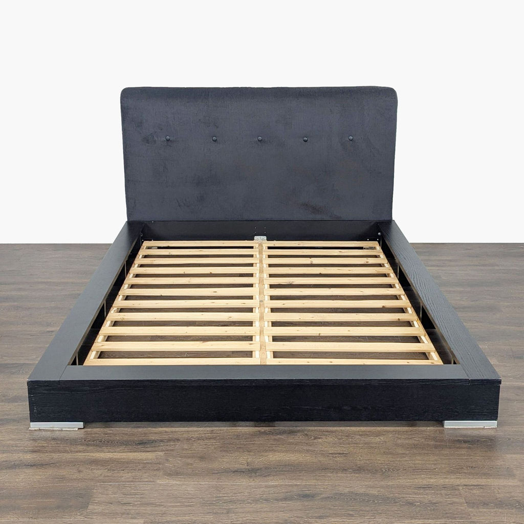 BoConcept black wooden bed frame with upholstered headboard and wooden slats, offering modern bedroom support.