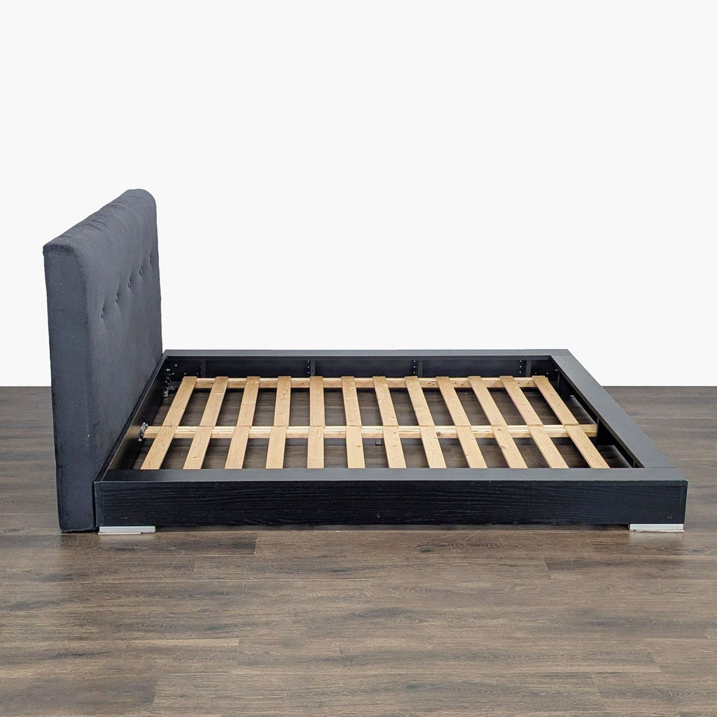 Modern BoConcept bed frame, featuring a black base and elegant upholstered headboard, ideal for stylish bedrooms.