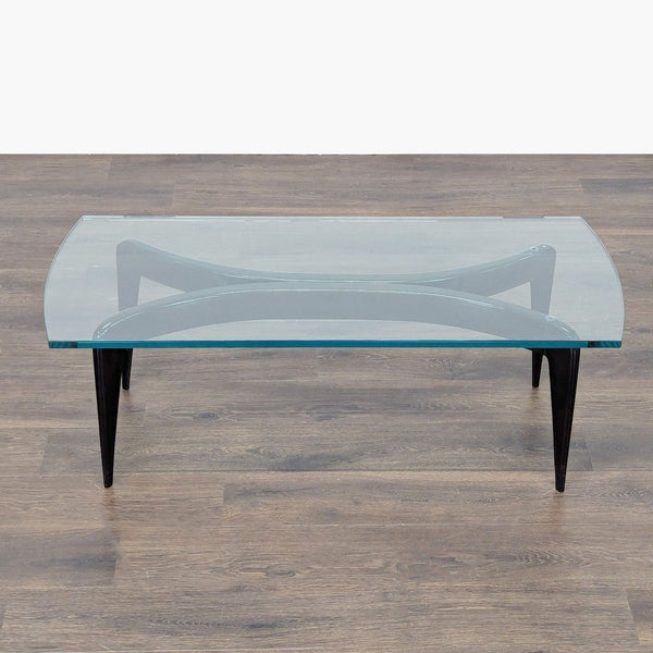 1. Rectangular Italian coffee table by Gio Ponti with black conical legs and a curved glass top.  