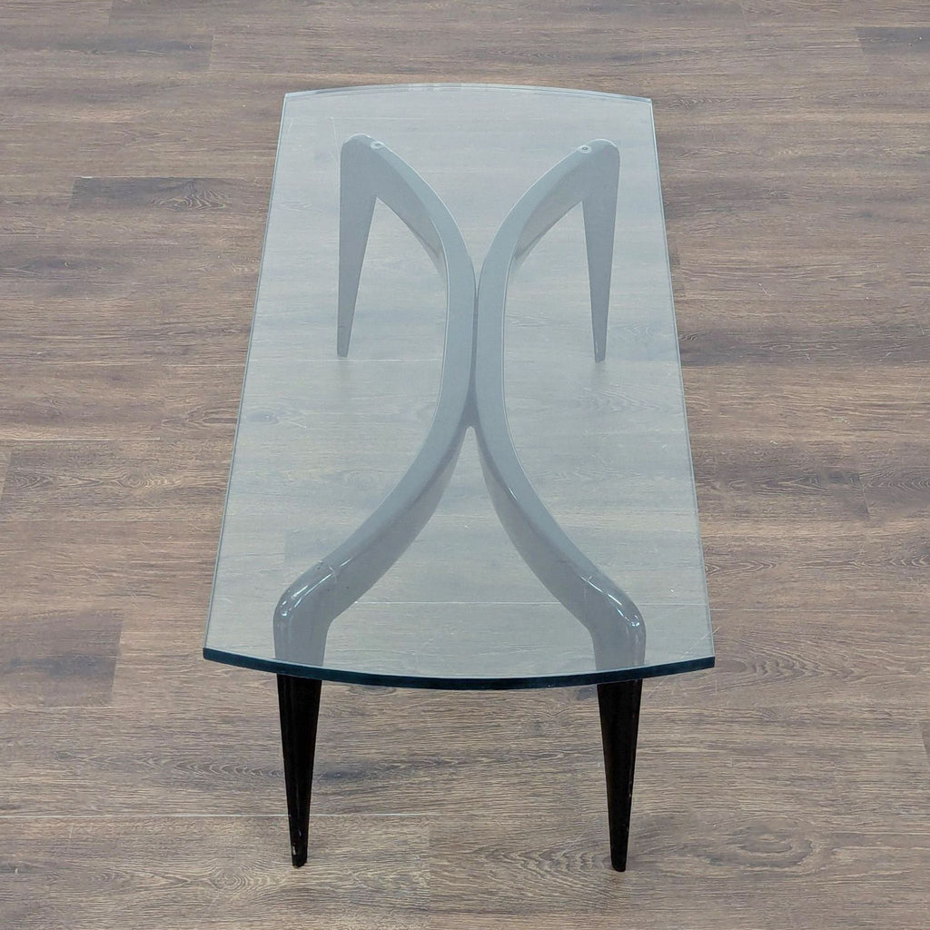 3. Top view of Gio Ponti coffee table highlighting its sculptural black frame and concave glass surface.