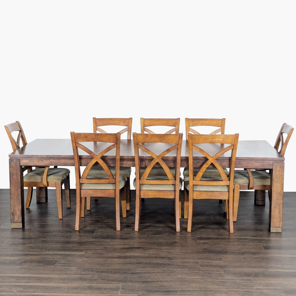 Bassett dining set with wood table, leaf extensions, and eight upholstered, cross-back chairs.