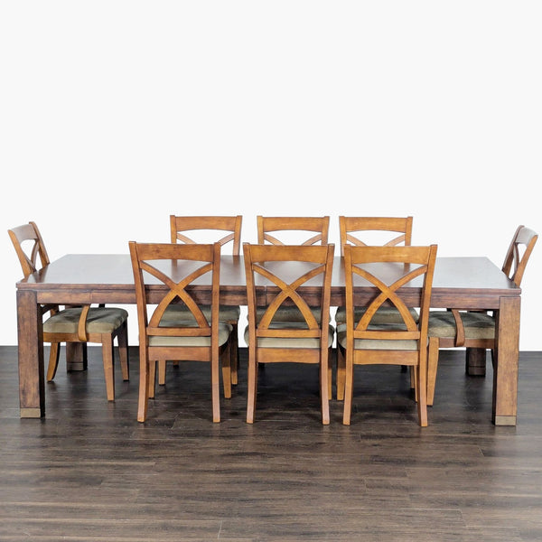 Bassett dining set with wood table, leaf extensions, and eight upholstered, cross-back chairs.