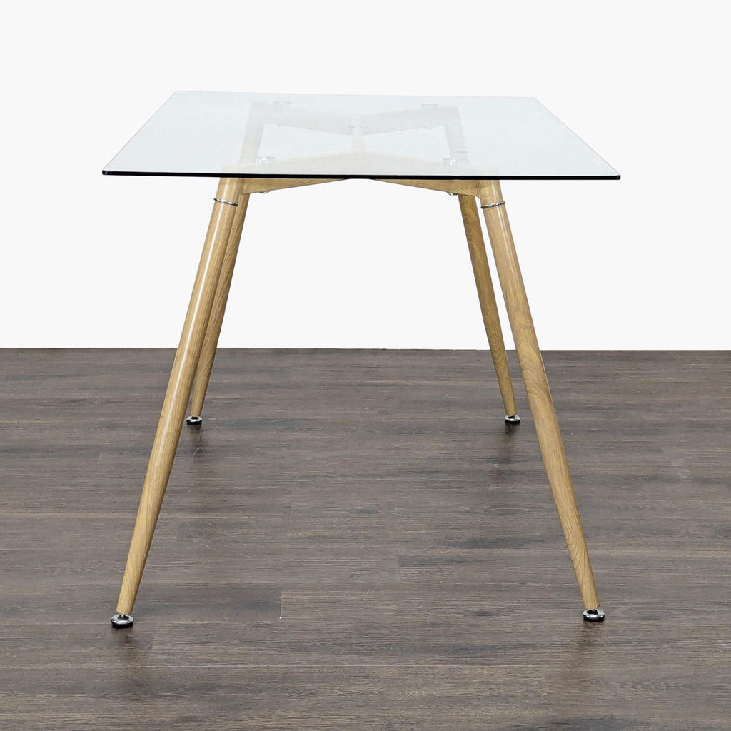 2. Modern dining table featuring a clear glass top and angled wooden legs, shown from a side angle.