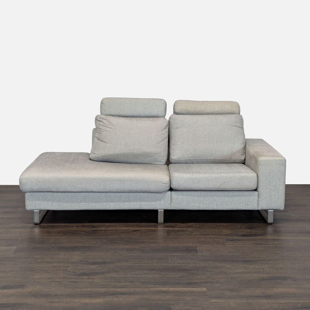 Light gray BoConcept sectional with adjustable headrests, metal legs, and modern design, ideal for spacious living rooms.
