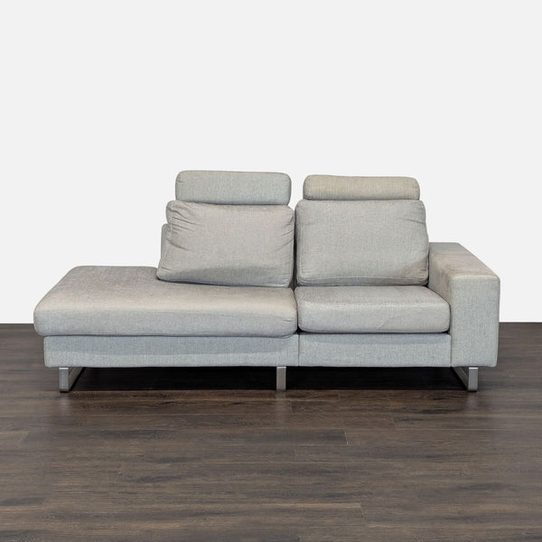 Light gray BoConcept sectional with adjustable headrests, metal legs, and modern design, ideal for spacious living rooms.