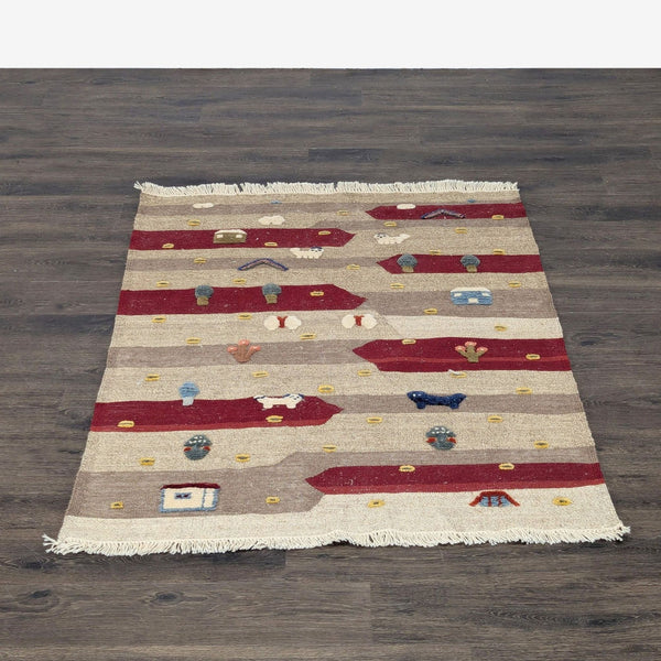Handmade wool rug with red and beige stripes, featuring playful animal and village motifs.  
