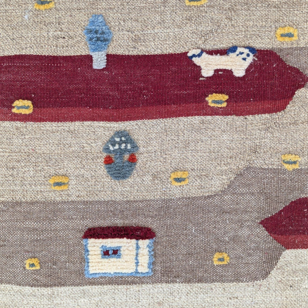 Cozy wool rug adorned with charming animals and village scenes in bold, striped patterns.  