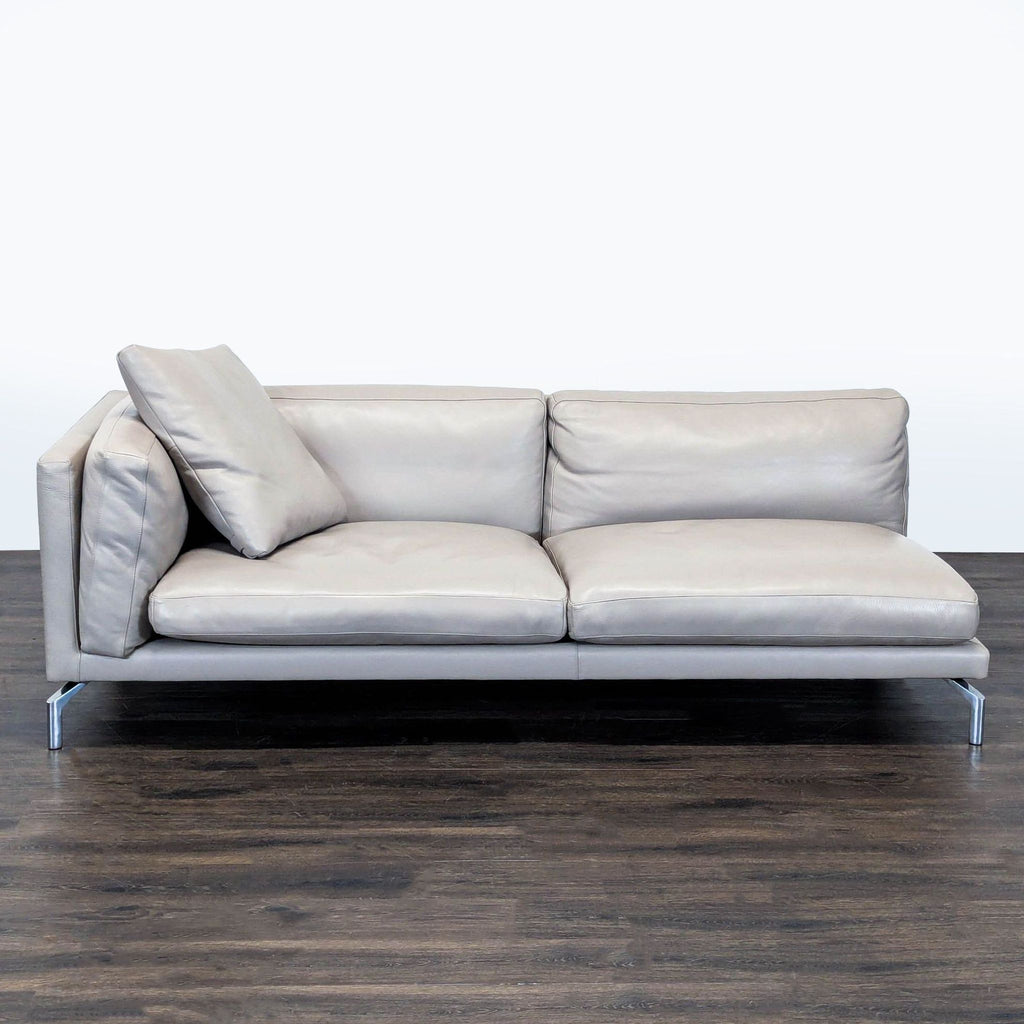 Modern Design Within Reach loveseat with soft grey leather and chrome legs, featuring deep, comfy cushions.