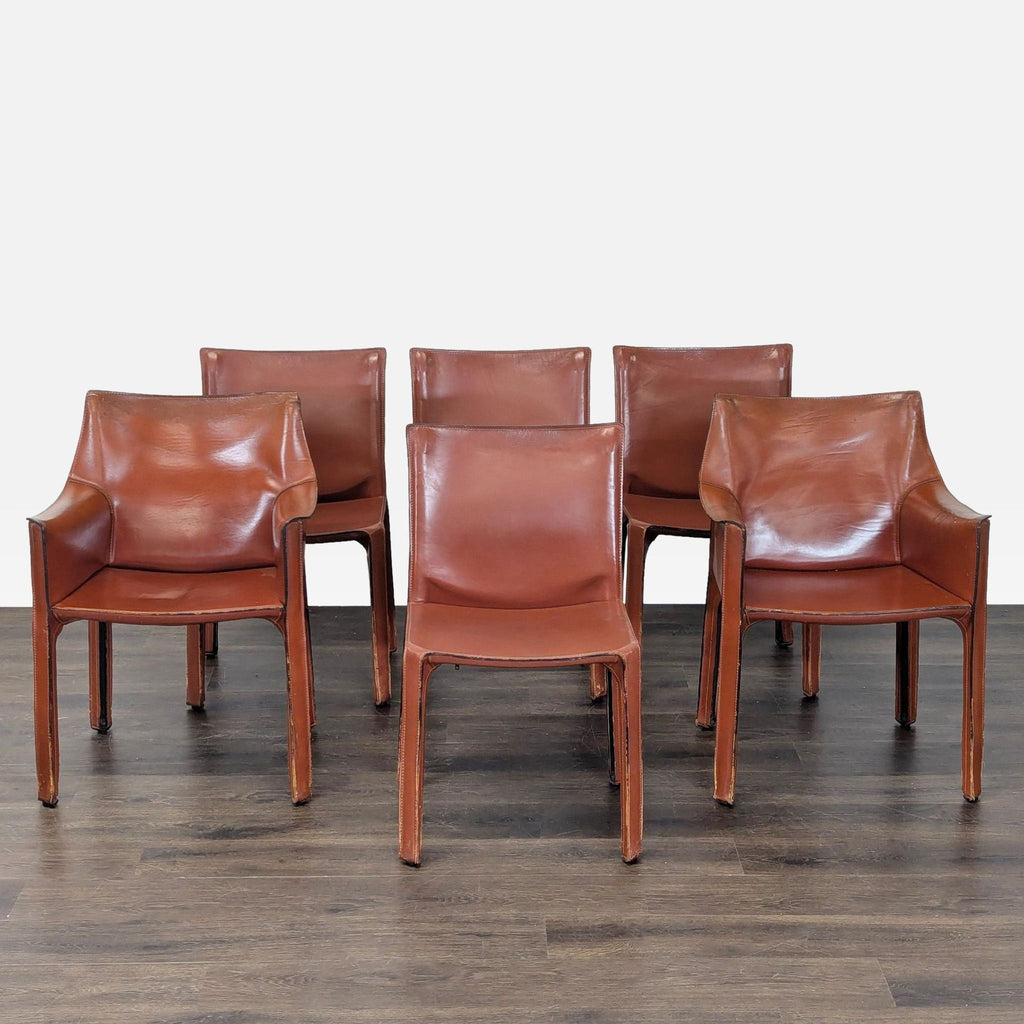Iconic Mario Bellini Cab dining chair with full leather upholstery, elegant stitching, and curved armrests.