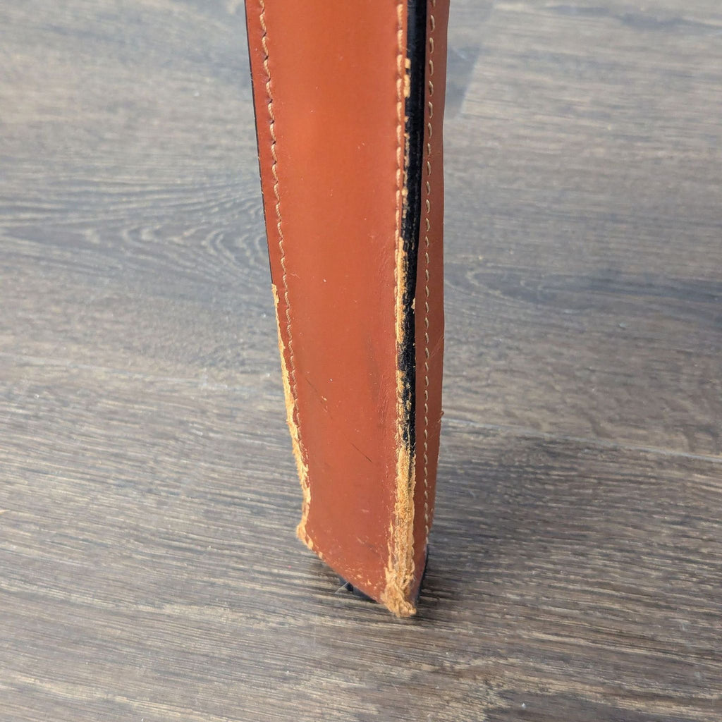 Dining chair by Mario Bellini for Cassina, featuring dynamic leather cover and delicate, curved armrest details.