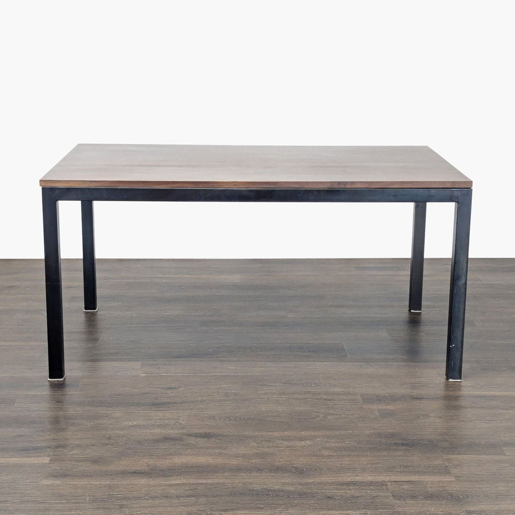 Crate & Barrel dining table with a wooden top and sturdy steel base.  