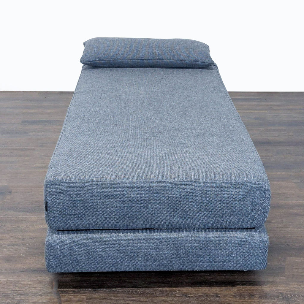 Modern blue Softline daybed sofa, includes a pillow, low-profile style, converts easily into twin beds.