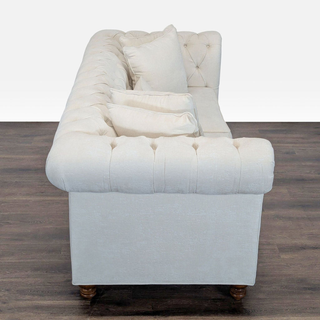 Chesterfield 3-seater sofa in soft cream with rolled arms, nailhead trim, and comfortable tufted back.