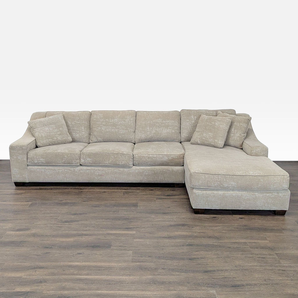 Beige sectional sofa with chaise lounge, three seats, and matching pillows, ideal for family relaxation.