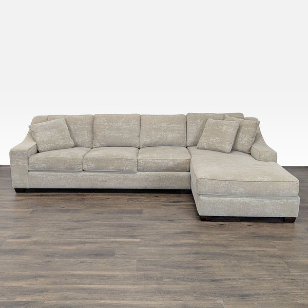 Beige sectional sofa with chaise lounge, three seats, and matching pillows, ideal for family relaxation.