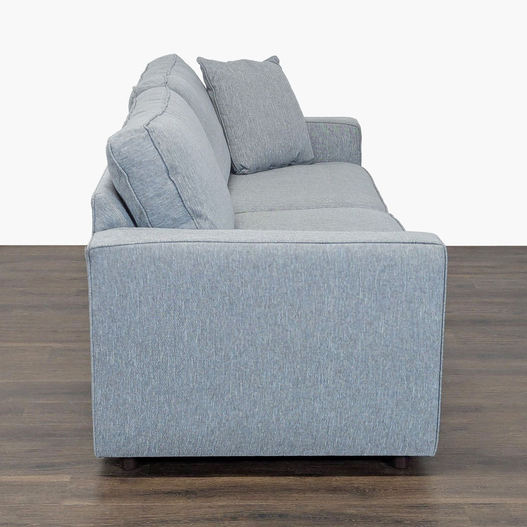 Stylish Room & Board gray sofa seats three; features contemporary lines and comfortable cushions.