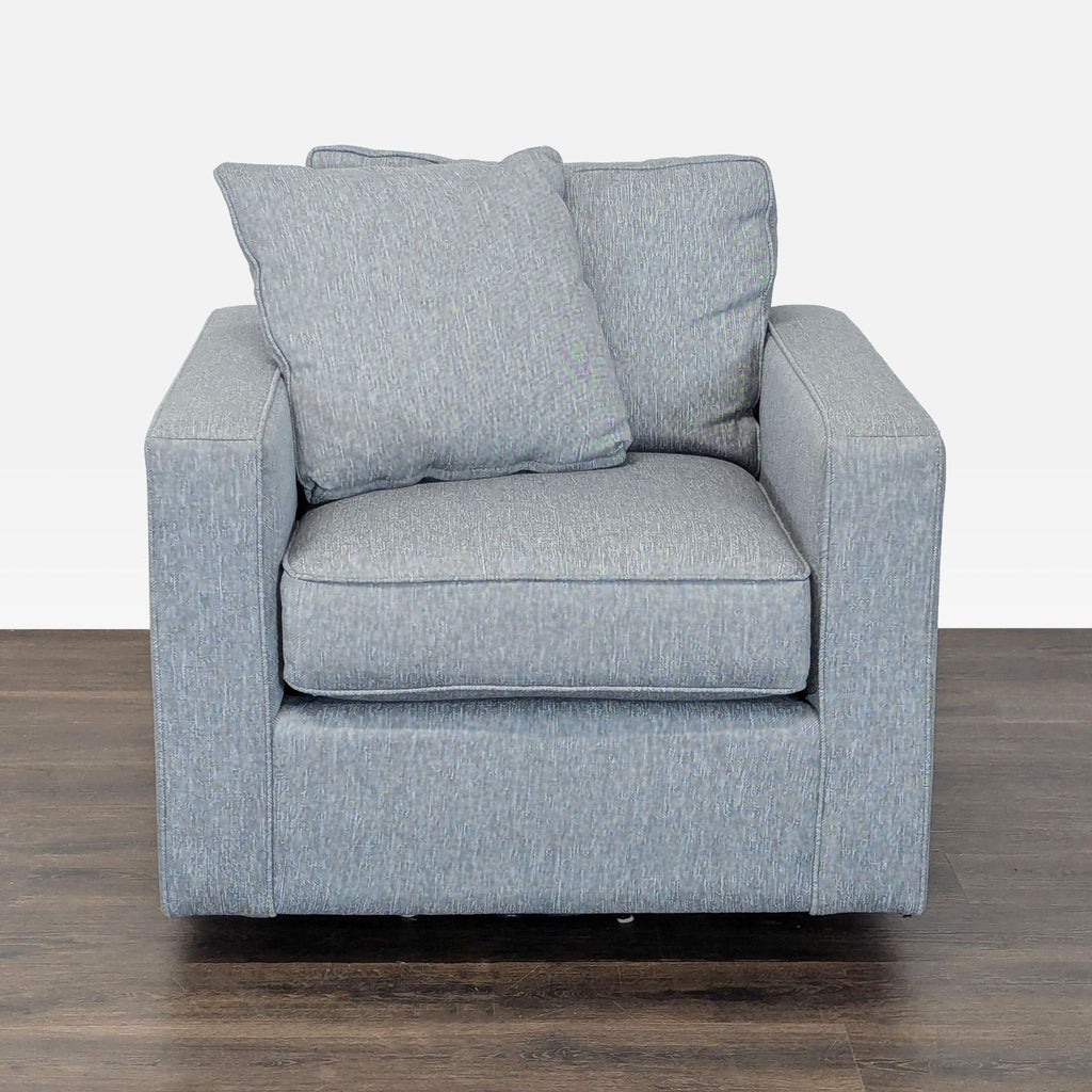 Modern blue Room & Board lounge chair with boxy design, thick cushions, and two matching pillows.