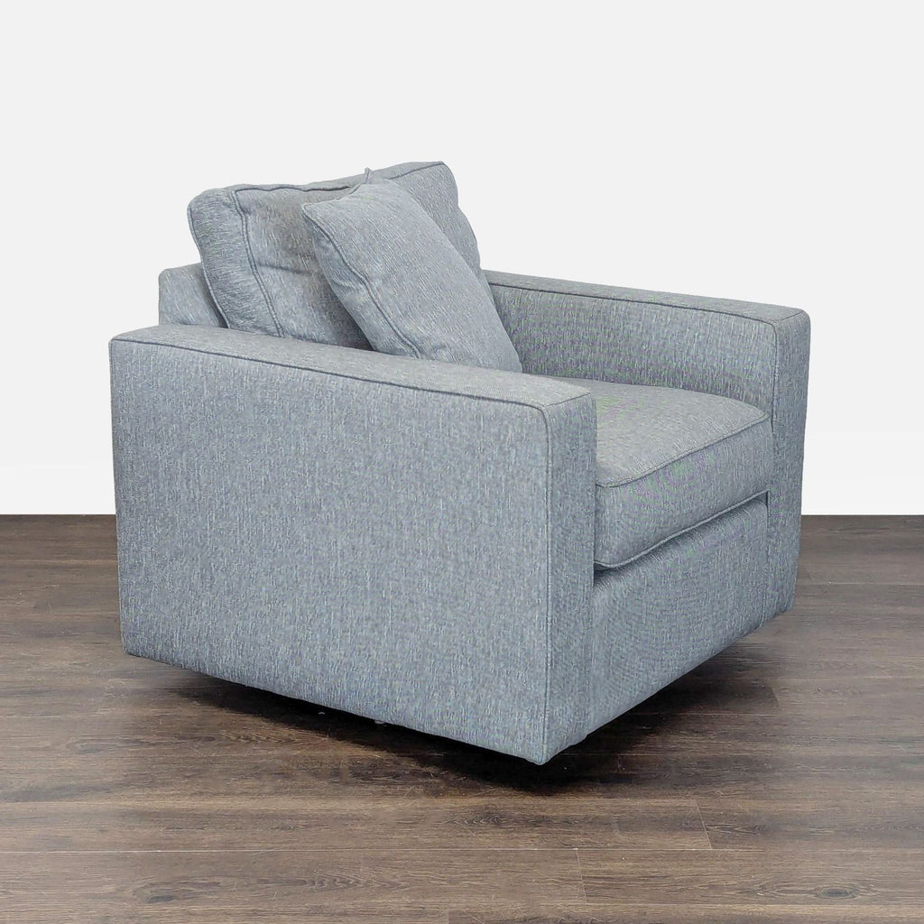 Boxy lounge chair in soft blue upholstery by Room & Board, featuring plush cushions and sleek style.