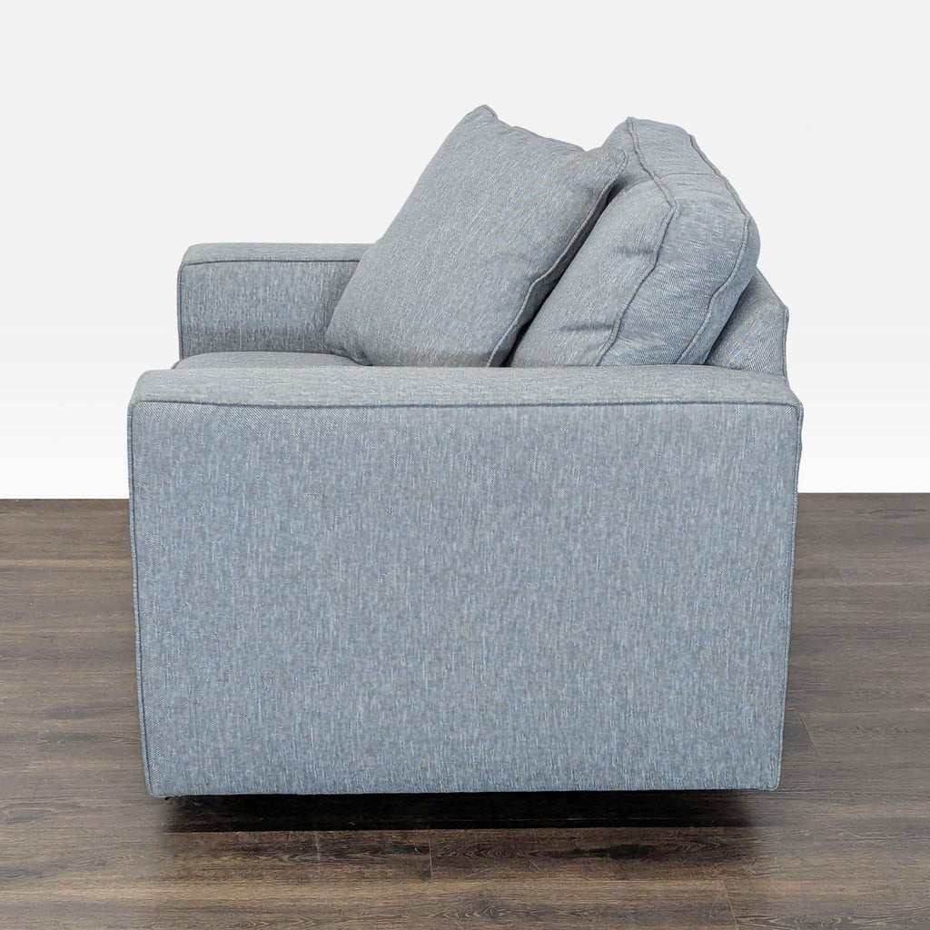 Room & Board lounge chair in blue, offering comfort with deep seat, back cushions, and extra pillows.